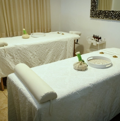 a massage table with white tablecloths