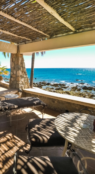 a patio with a view of the ocean