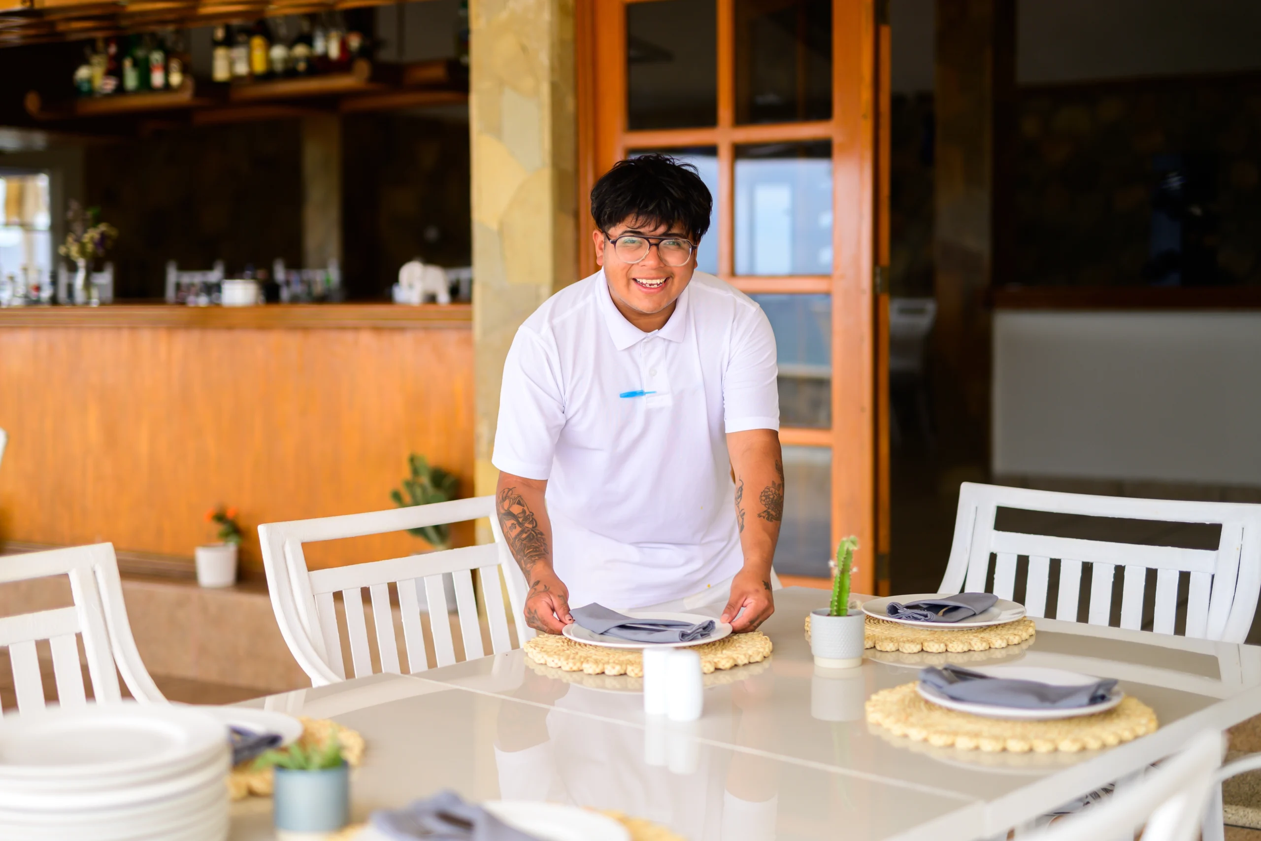 a man smiling at a table